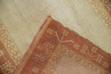 Distressed vintage Oushak rug corner with ivory-platinum pile, original cord selvage, and terra cotta reverse.