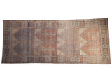 Vintage distressed Oushak rug, faded blue, pale brick prayer motifs, geometric palmette border.