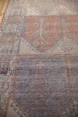 Distressed Turkish Oushak runner: faded brick and pale blue prayer motif panels.