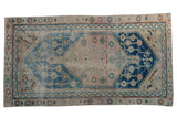 Vintage distressed Anatolian rug, indigo blue medallion, geometric vinery on a sand and blush field, 3'1
