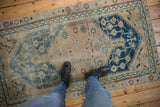 Distressed Anatolian rug with indigo blue medallion, geometric vinery, sand and blush tones.