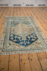 Hand knotted Anatolian rug with distressed indigo medallion, geometric vinery, floral field.