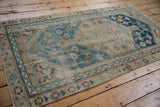 Distressed vintage Anatolian rug with geometric indigo blue vinery and sand tones.