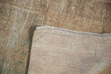 Distressed Oushak rug runner showing textured pile, exposed foundation, and intact selvage.
