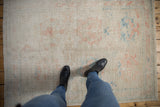 Soft, hand knotted distressed Oushak rug pile with faded ivory, pink, and blue floral palmettes.