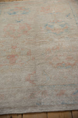 Lustrous, distressed Oushak rug pile exhibiting faded pale pink and sky blue palmettes.