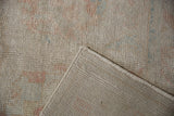 Vintage distressed Oushak rug pile texture with subtle pastel colors and woven back.