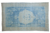 Vintage distressed Oushak carpet in powder blue and ivory with a central tree-of-life medallion.