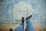 Overhead view of a distressed Oushak carpet showing its soft, low pile and even wear.