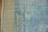 Even wear on the knot heads of a distressed Oushak carpet in dusty blue and sand.