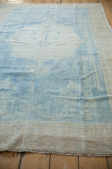 Low pile texture and even wear down to the knot heads on a vintage distressed Oushak rug.