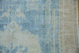 Detailed view of the distressed Oushak's even wear, showing visible knot heads and texture.