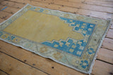 Corner detail of distressed Oushak rug, showing sky blue pattern and original selvage.