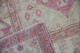 Distressed Oushak rug pile showing even wear, faint foundation, and detailed reverse.