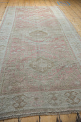 Distressed Oushak runner pile, showing even wear and dusty raspberry geometric patterns.