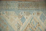 Distressed Oushak rug border and field with powder blue, ivory, beige patterns.