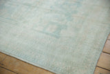 Distressed Oushak rug runner, worn pile texture, faint geometric leaves, ivory, pale denim blue, intact selvage.