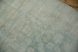 Distressed Oushak runner pile displaying soft blue, ivory geometric patterns, and even wear.
