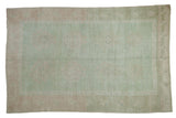 Vintage distressed Oushak rug, faded seafoam green, muted floral guls, starburst border.