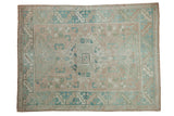 Distressed vintage Melas rug with faded beige, powder blue diamond medallion, and geometric borders. 4'7