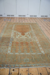 Vintage distressed Oushak rug, showing even wear, prayer design, and copper and sea foam palette.