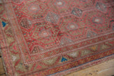Distressed Oushak runner detail: dusty raspberry red field, serrated main border, rams horn motif.