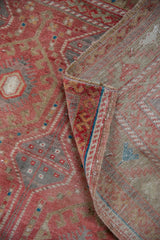 Distressed Oushak runner showing raspberry, slate pile texture and hand-knotted woven foundation.