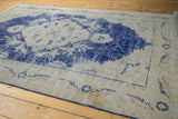 Distressed Vintage Oushak border featuring cobalt blue serrated leaf and floral patterns.