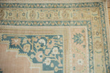 Vintage Distressed Oushak carpet corner with pale apricot, dusty navy floral and vine borders.