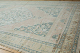 Distressed vintage Oushak rug corner with abrashed germinating plant border motif.