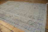 Textured pale royal blue and antique ivory floral main border on a distressed vintage Oushak rug.