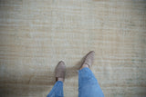 Distressed Oushak rug, worn pile revealing foundation, in ivory, cream, seafoam green.