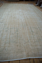 Distressed vintage Oushak carpet with worn pile and exposed foundation.