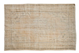 Distressed vintage Oushak carpet, faded quatrefoil medallion and palmette borders in soft ivory hues.