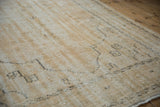 Distressed vintage Oushak carpet pile showing worn texture and soft cream tones.