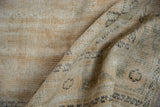 Distressed vintage Oushak rug pile revealing worn knot heads and subtle ivory, sand tones.