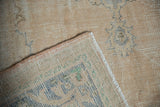 Hand-knotted foundation and intact selvage of a distressed beige Oushak carpet.