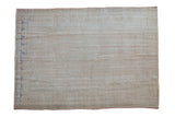 Distressed Oushak carpet with a faint center medallion in soft ivory, blush, and pale blue.