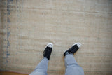 A view of the distressed Oushak carpet's low-pile texture and hand-knotted, time-softened surface.