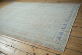 Low-pile texture and time-softened abrash on the corner of a vintage Oushak carpet.