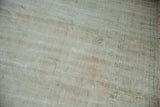The hand-knotted foundation and weave on the reverse of a distressed Turkish carpet.