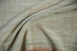 Reverse of a vintage Turkish rug showing the hand-knotted foundation and textured ivory weave.