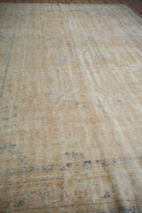 Distressed hand knotted Oushak pile showcasing faded cream and dusty blue patterns.