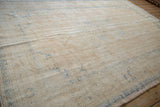 Textured detail of distressed vintage Oushak carpet, showing worn pile and visible foundation.