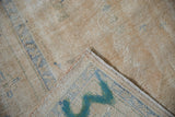 Distressed pile texture of vintage Oushak rug, revealing foundation and hand-knotted reverse.