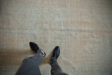 Distressed vintage Oushak rug texture, showing wear to foundation and subtle color variations.