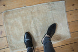Vintage distressed Oushak rug mat with soft pile and muted geometric design.