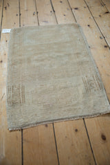 Distressed Turkish Oushak rug mat with faded geometric medallions, in soft ivory.