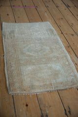 Distressed Oushak rug bottom edge with short fringe and intact side selvage.