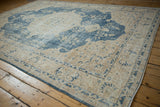 Angled view of vintage distressed Sparta carpet with faded denim blue patterns.